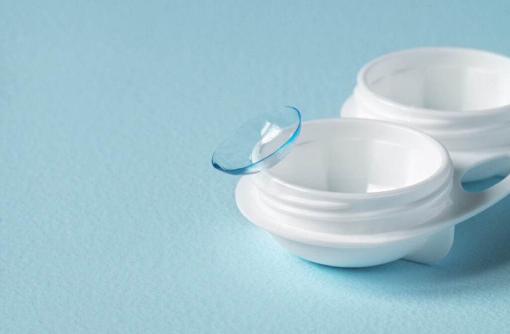 A contact lens on top of a contact lens container.